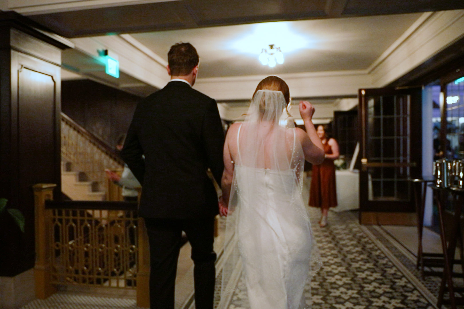 Bride in short 90s inspired reception dress at her Hotel Northland wedding