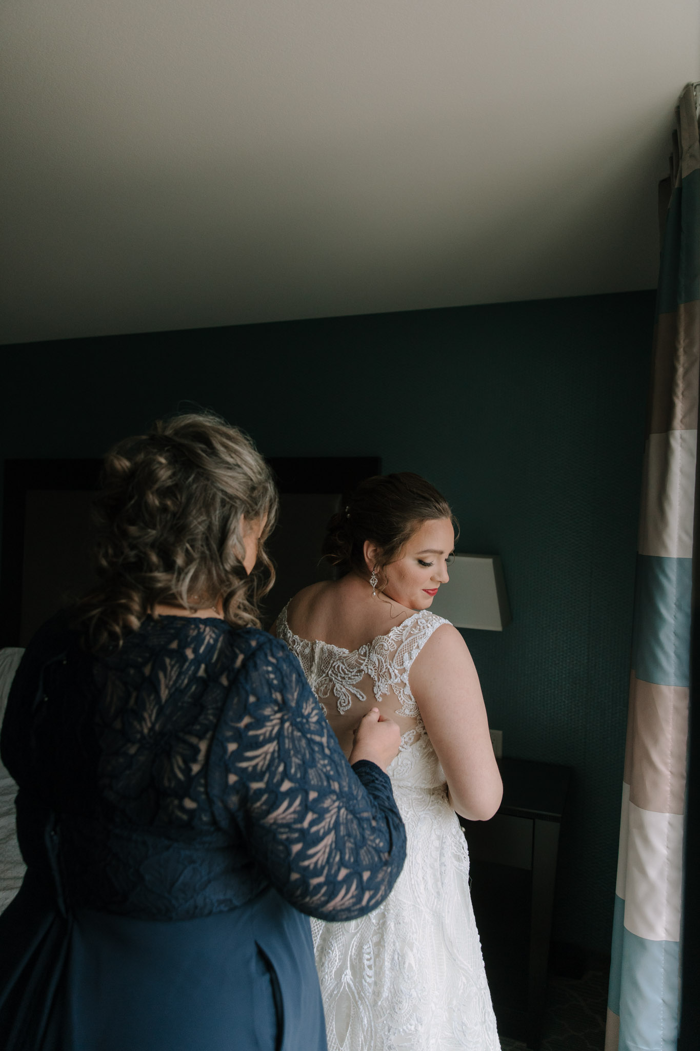 Mom helping bride into dress - Hilton Homewood Suites - Wauwatosa