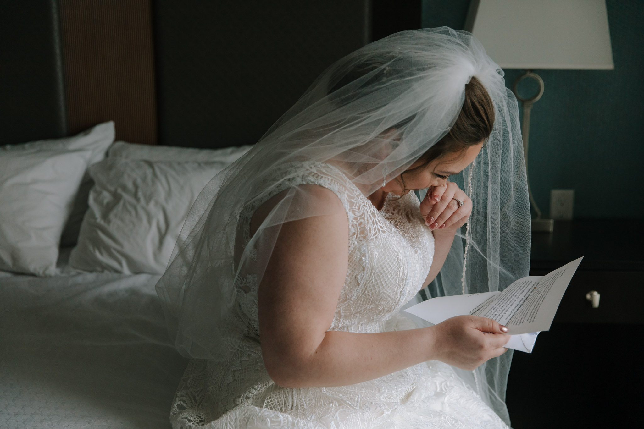 Bride reading letter from groom before St Stanislaus wedding - Fine art wedding photo - Hilton Homewood Suites - Wauwatosa