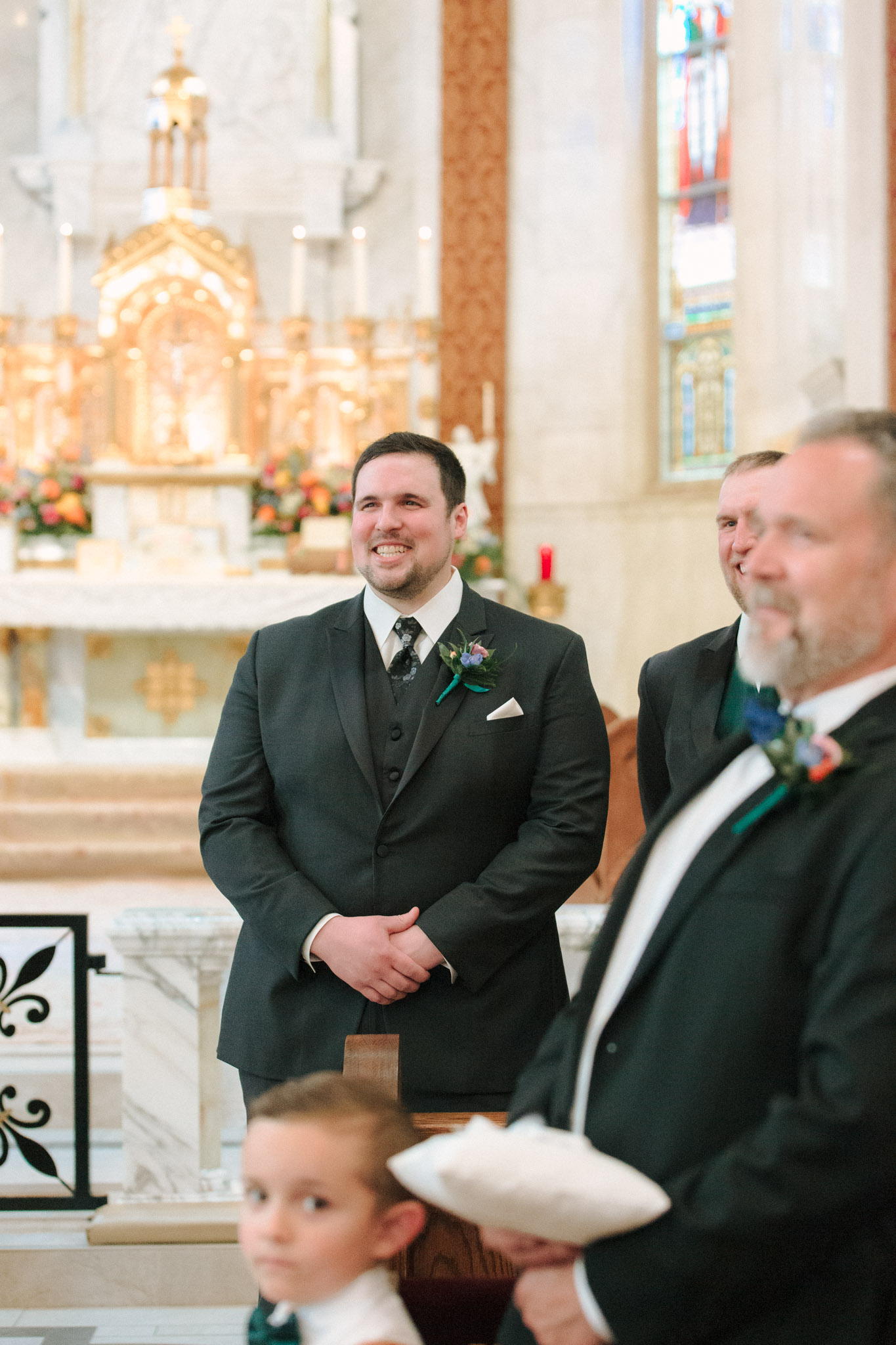 Groom with a big smile on his face watching bride come down the aisle - St Stanislaus wedding