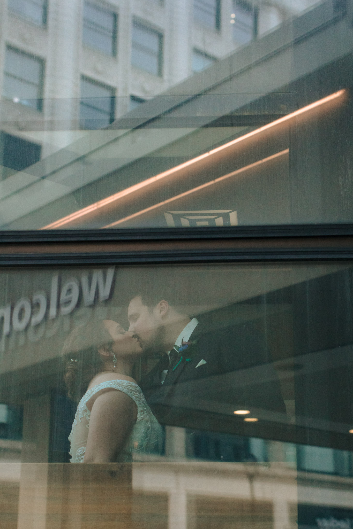Bride and groom kissing in elevator