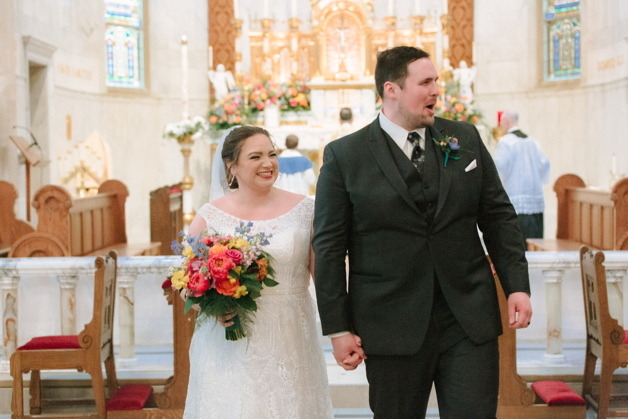 Happy bride and groom walking down the aisle - St Stanislaus wedding