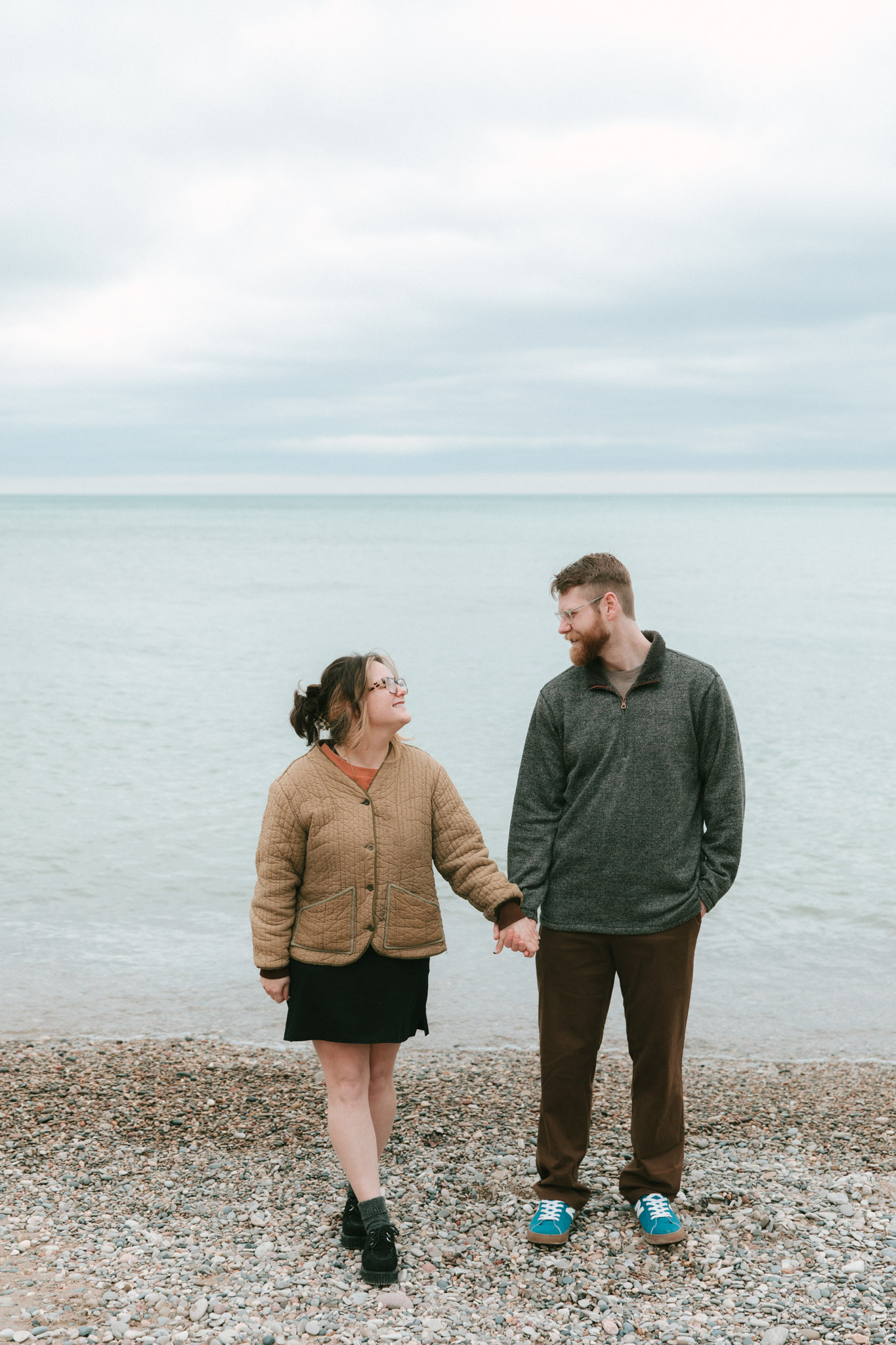 couple holding hands on Lake Michigan in Milwaukee Chicago