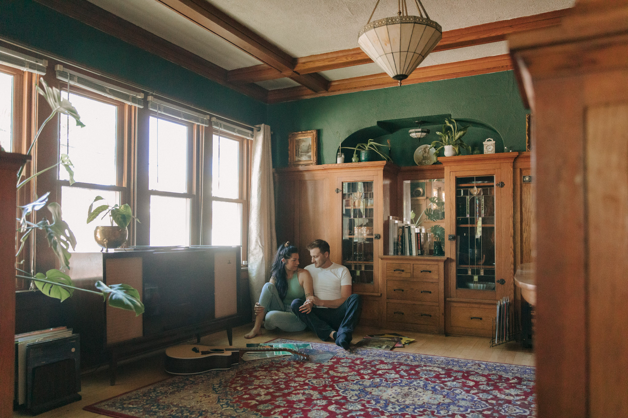 Couple wearing a simple engagement session outfit. The girl is wearing a sage green fitted crop top with light blue jeans and the guy is wearing a white t shirt and black jeans