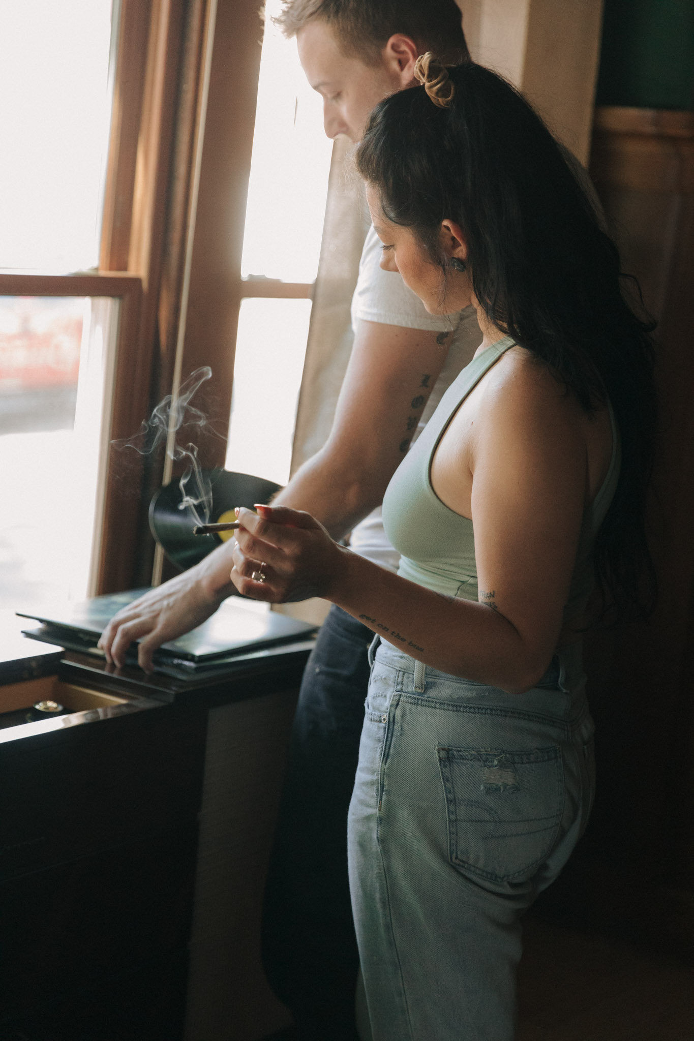 Retro 1960s inspired engagement photos with a blunt, record player, and guitar