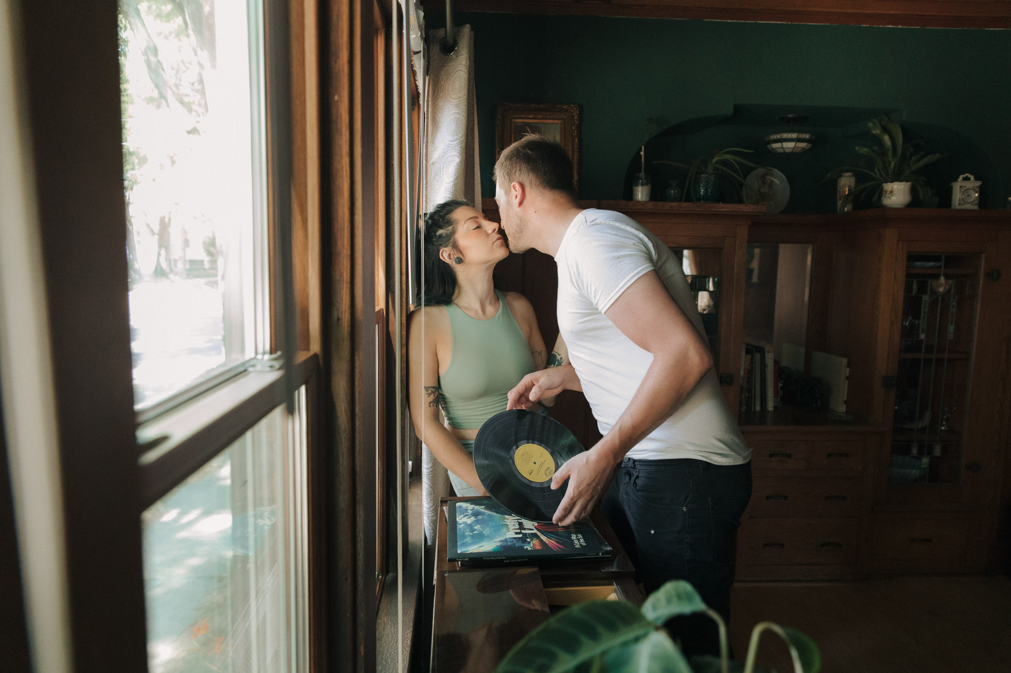 Milwaukee engagement photographers listening to records and smoking during their photo session