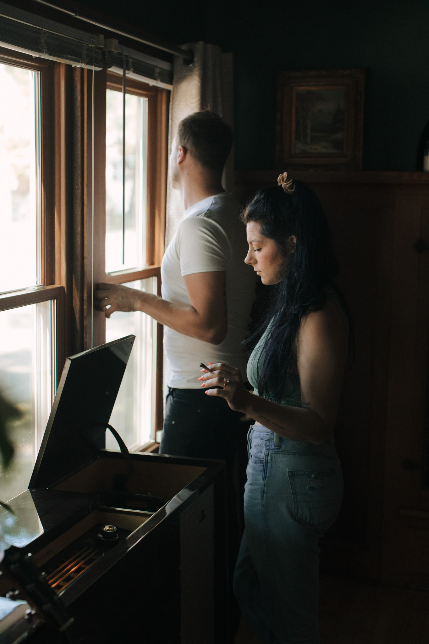 Milwaukee engagement photographers listening to records and smoking during their photo session