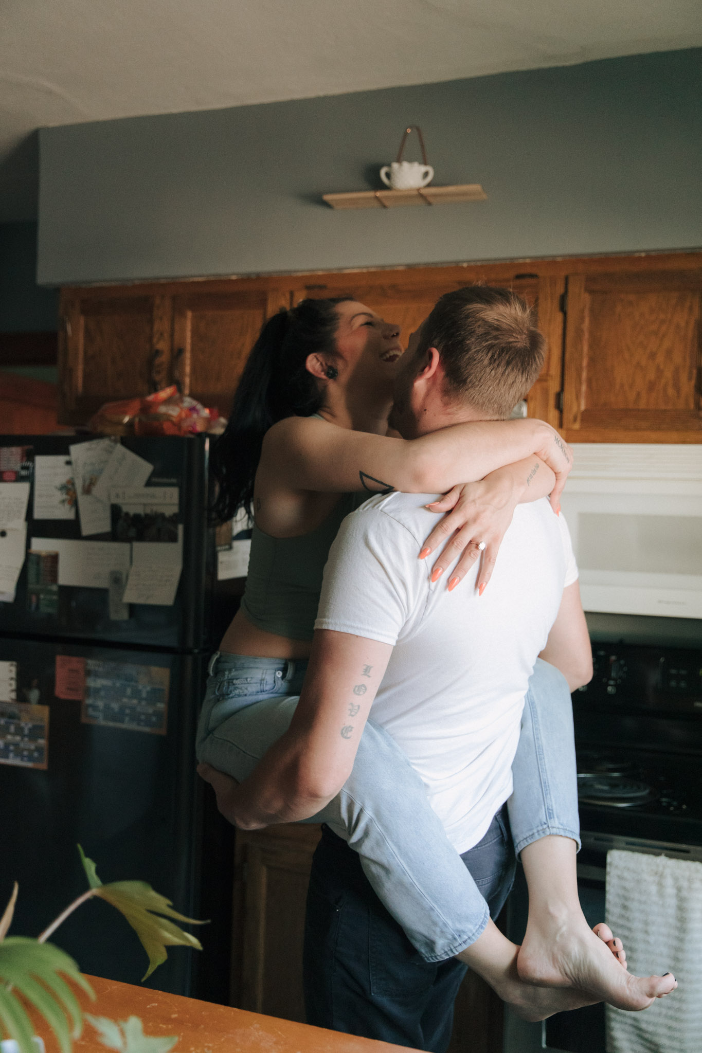 Couple being silly in the kitchen during their Milwaukee engagement session