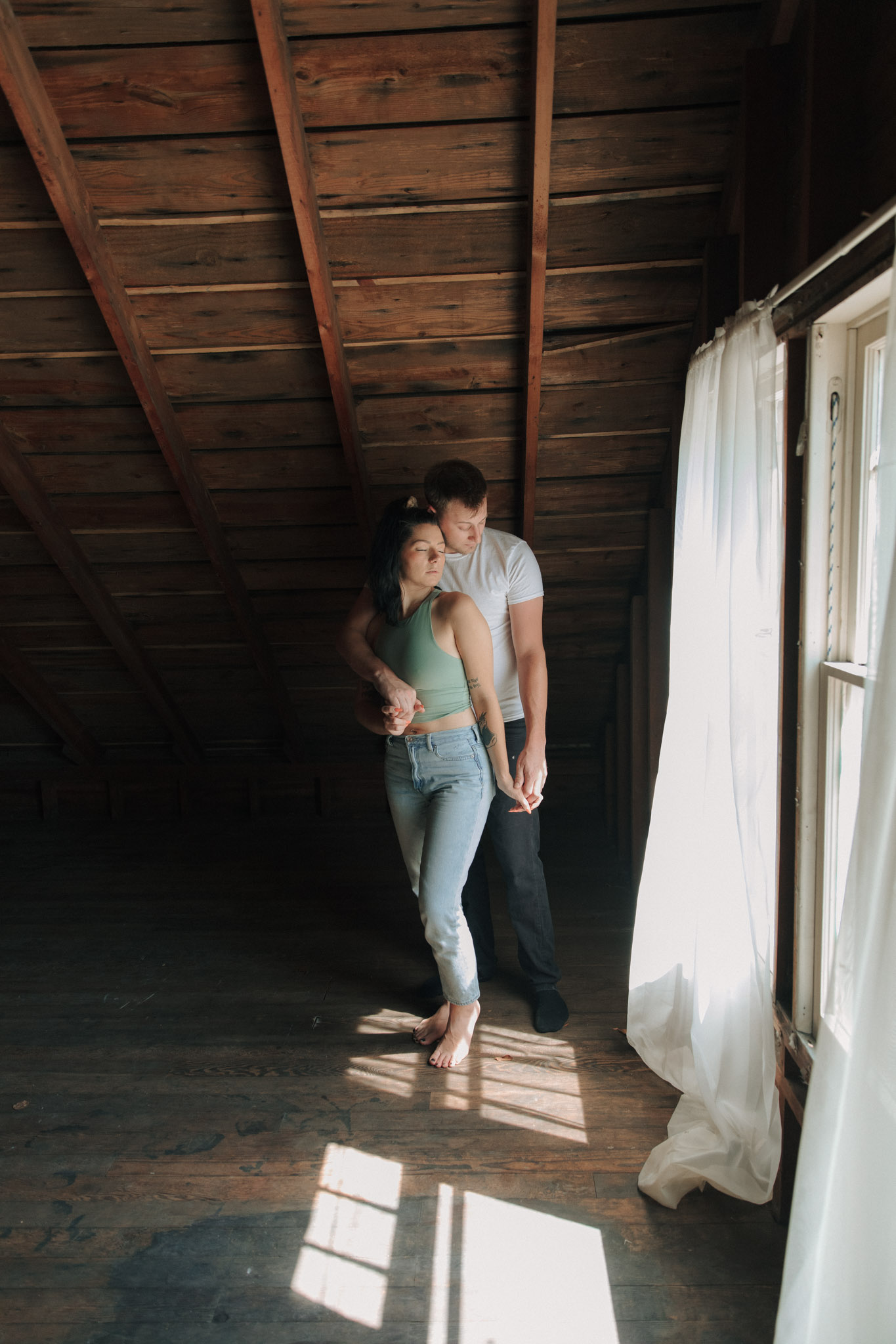 Moody engagement session picture in a Milwaukee attic