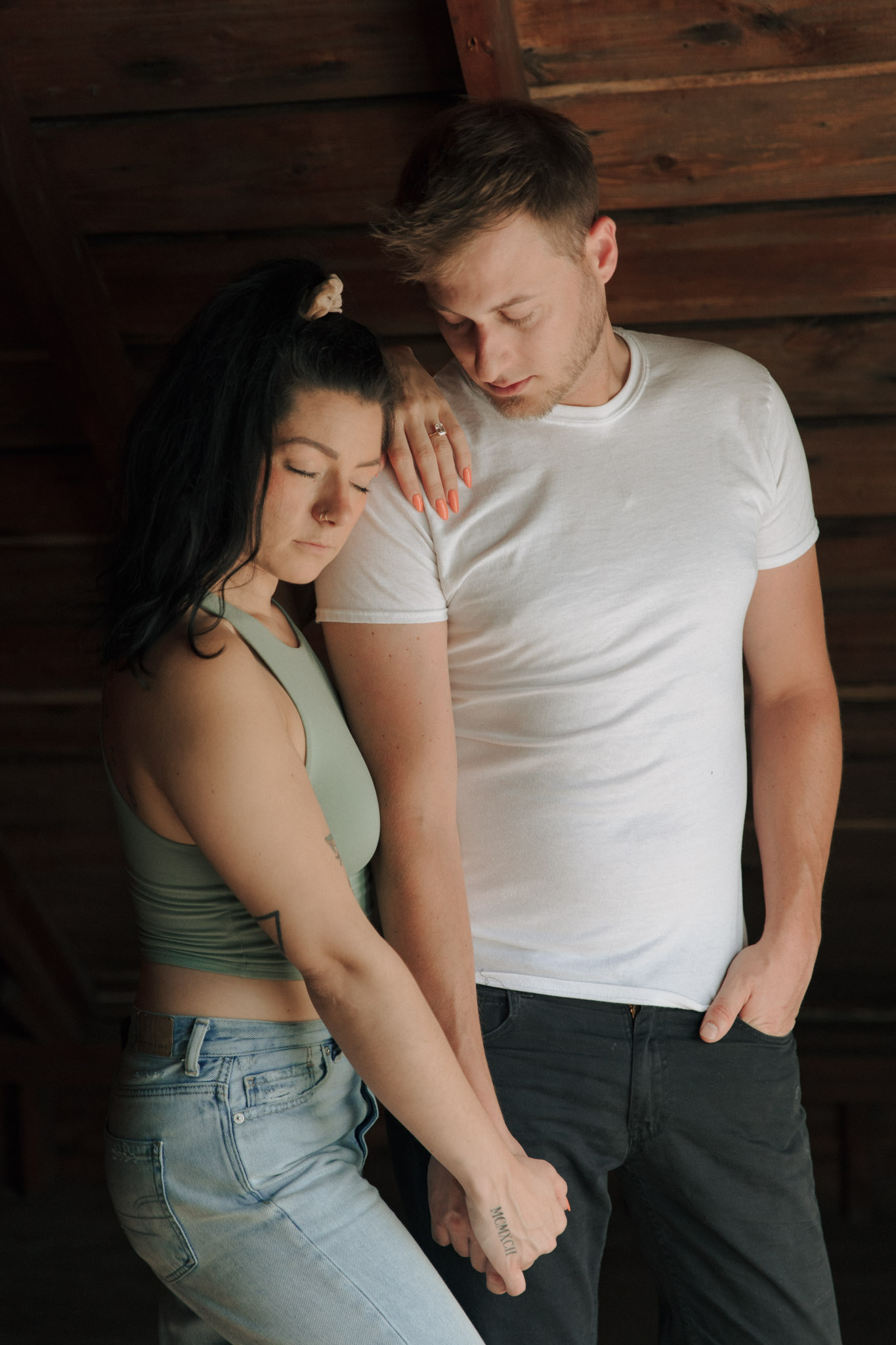 Moody engagement session picture in a Milwaukee attic