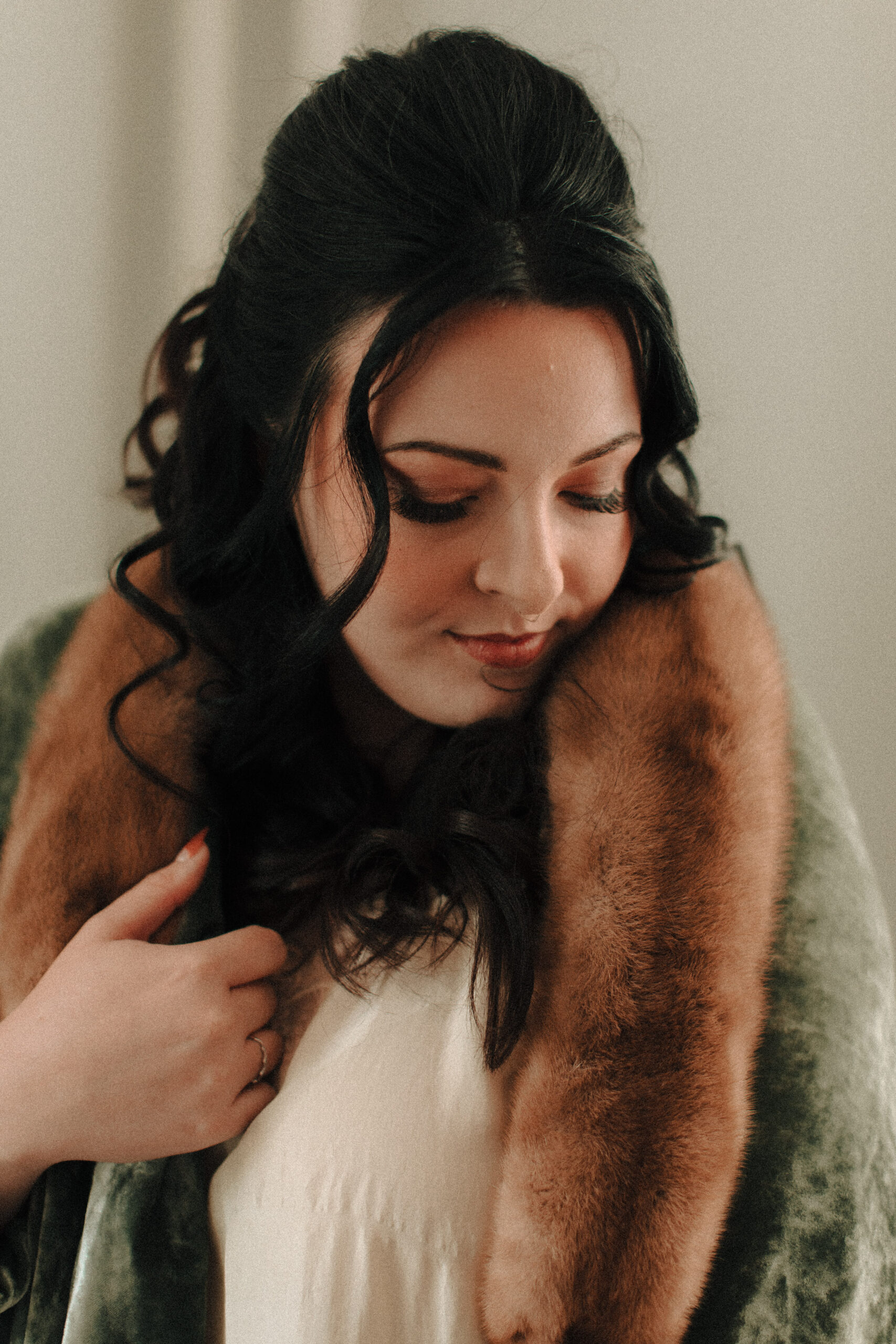 Bride with Priscilla Presley inspired retro hair and makeup wearing a green velvet robe with a fur collar and european vintage nightgown