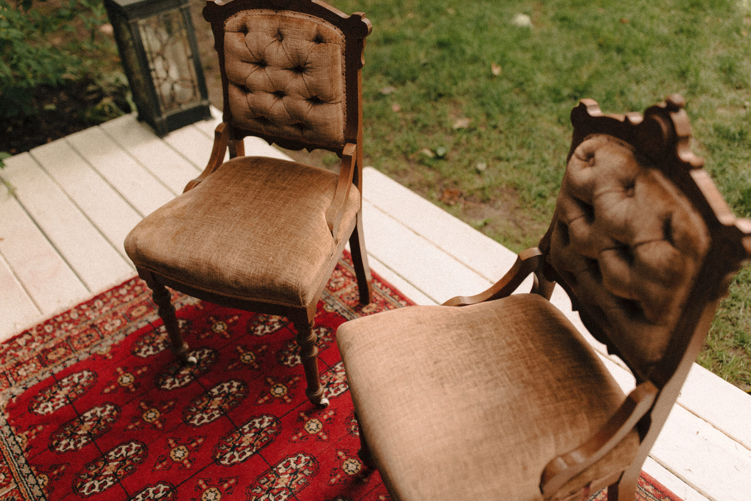 victorian revival romantic wedding ceremony altar with boho red rug and upholstered chairs