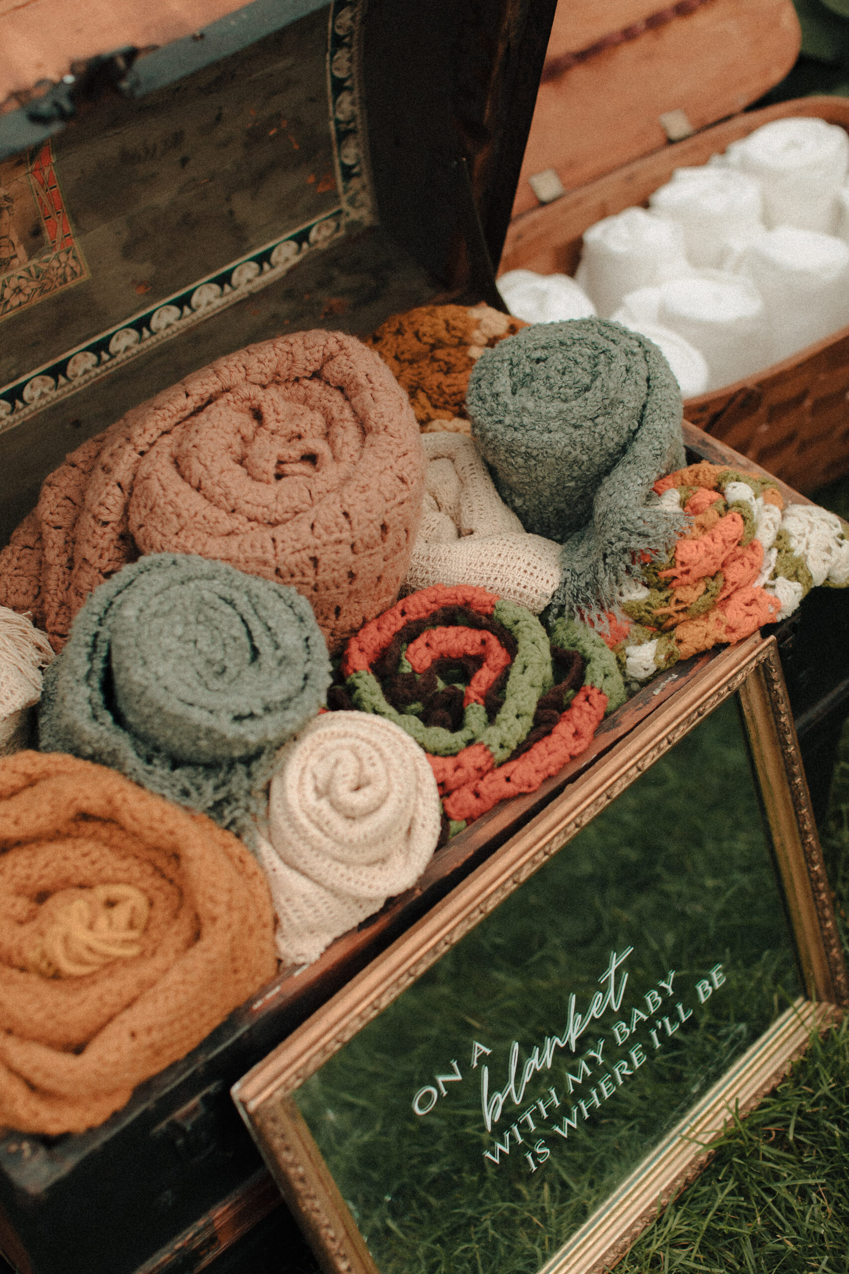 hand crocheted afghan throw blankets in a vintage trunk for wedding guests who get cold