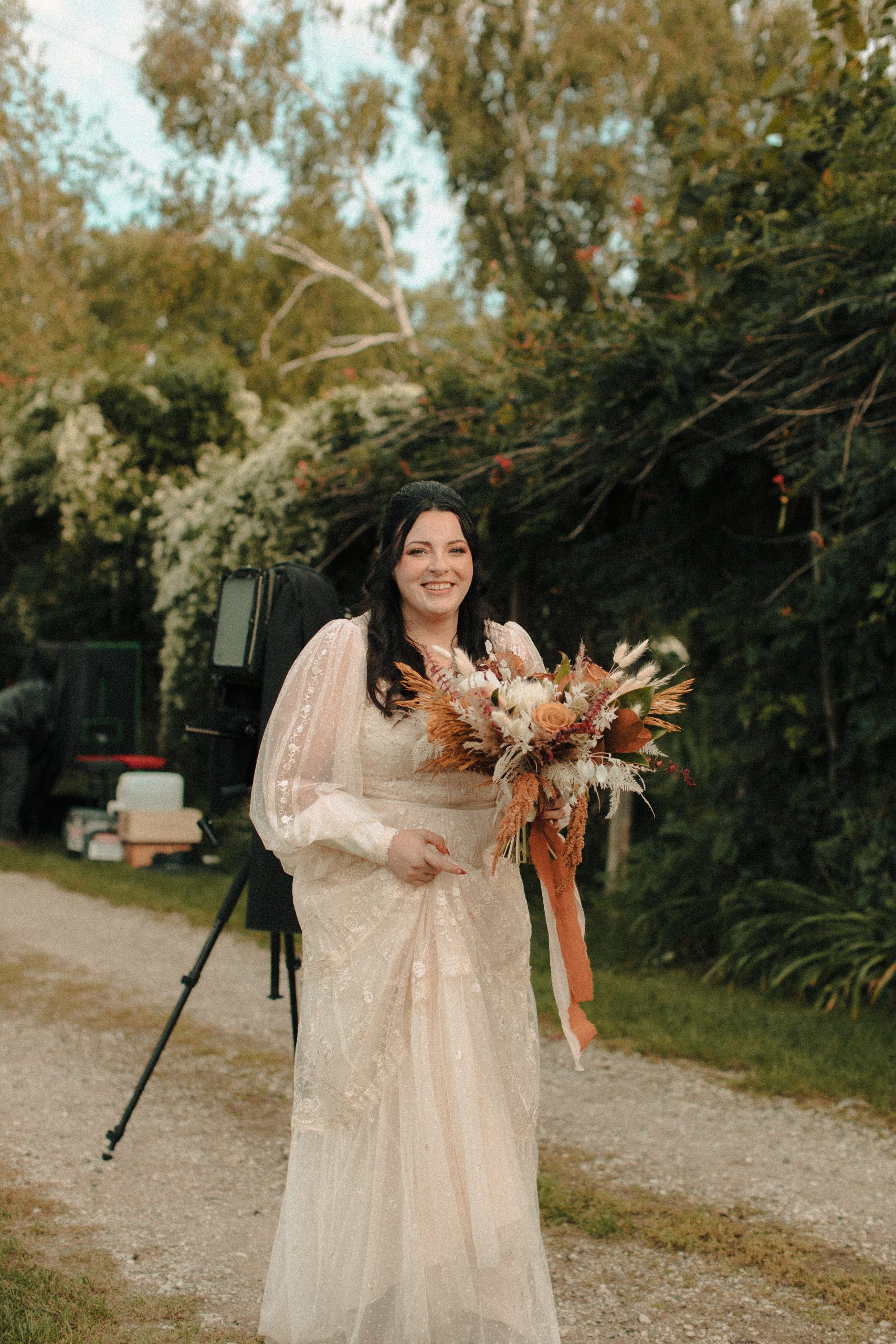 Bride smiling after having a tintype photograph taken of her