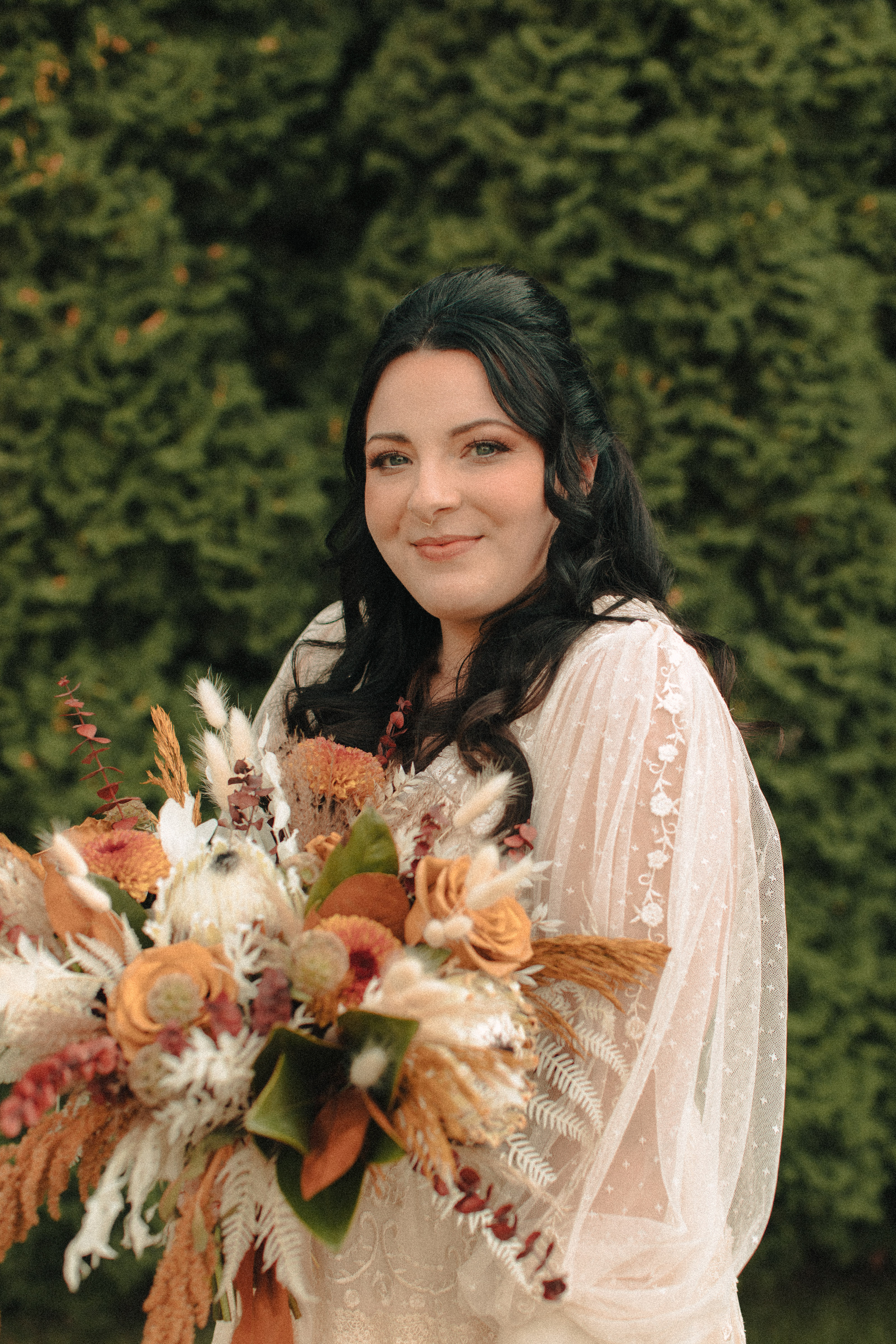 retro inspired hair and makeup on a bride holding whimsical flowers