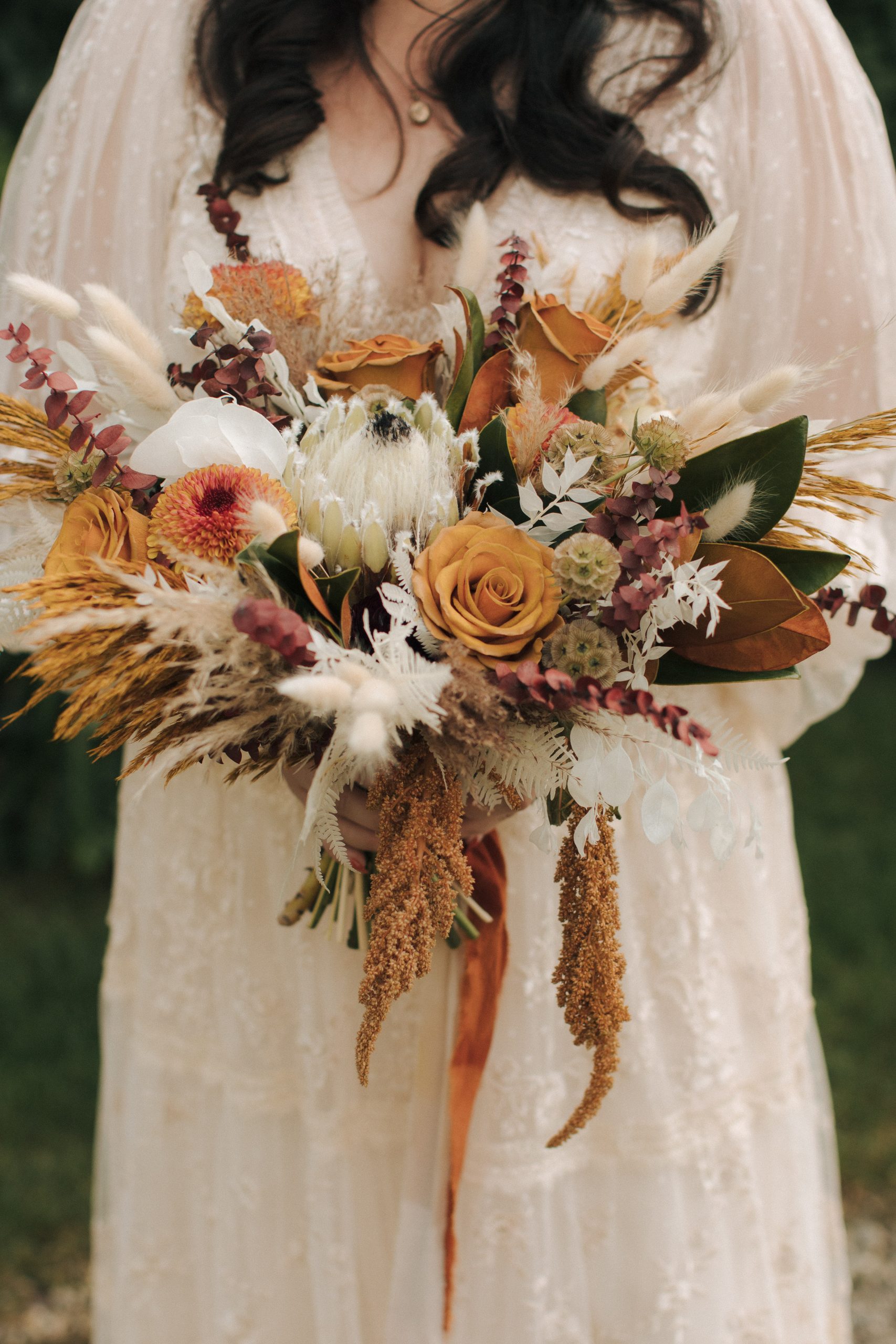 closeup photo of whimsical flowers with shades of orange, red, green, and white