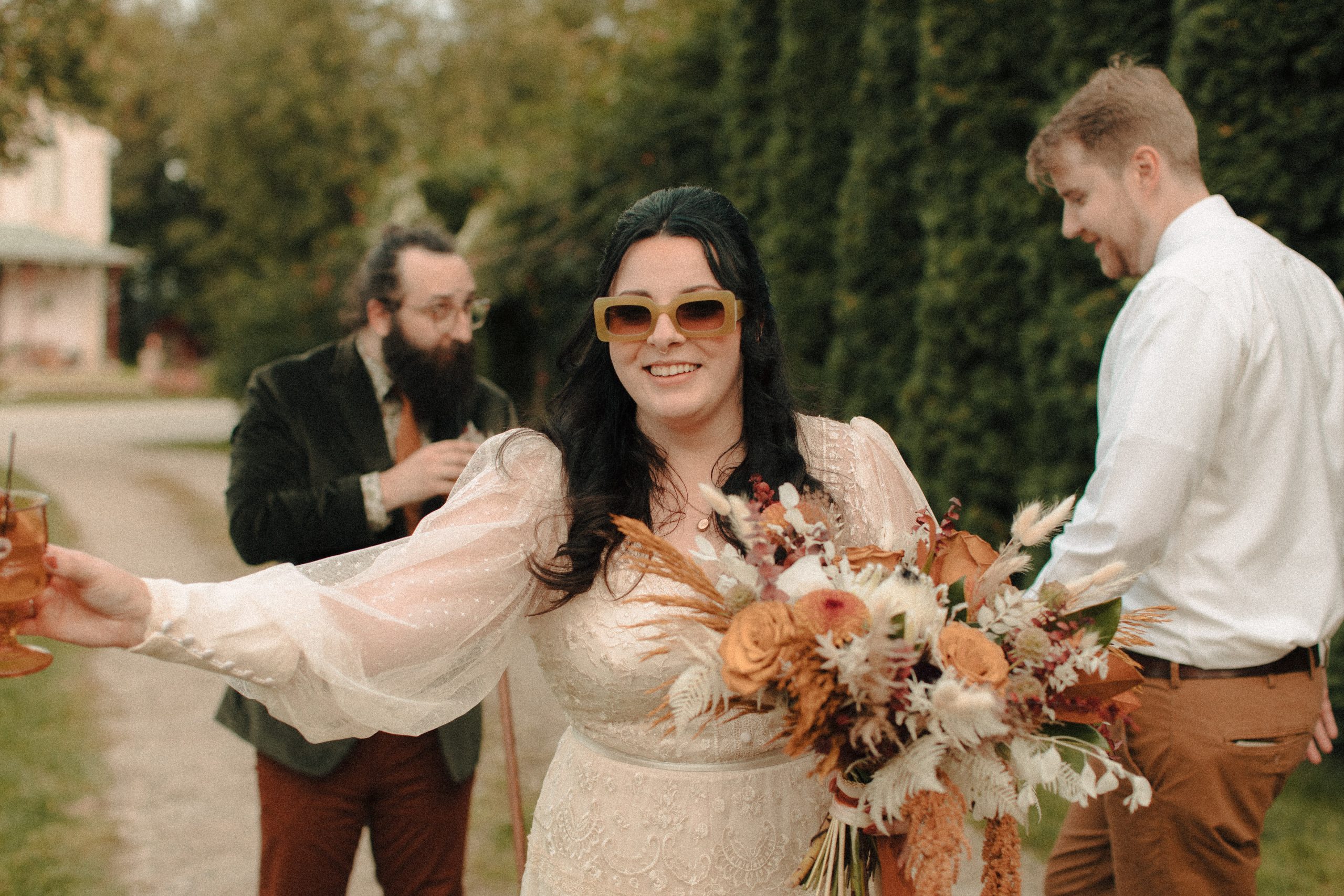 Bride wearing retro green sunglasses celebrating