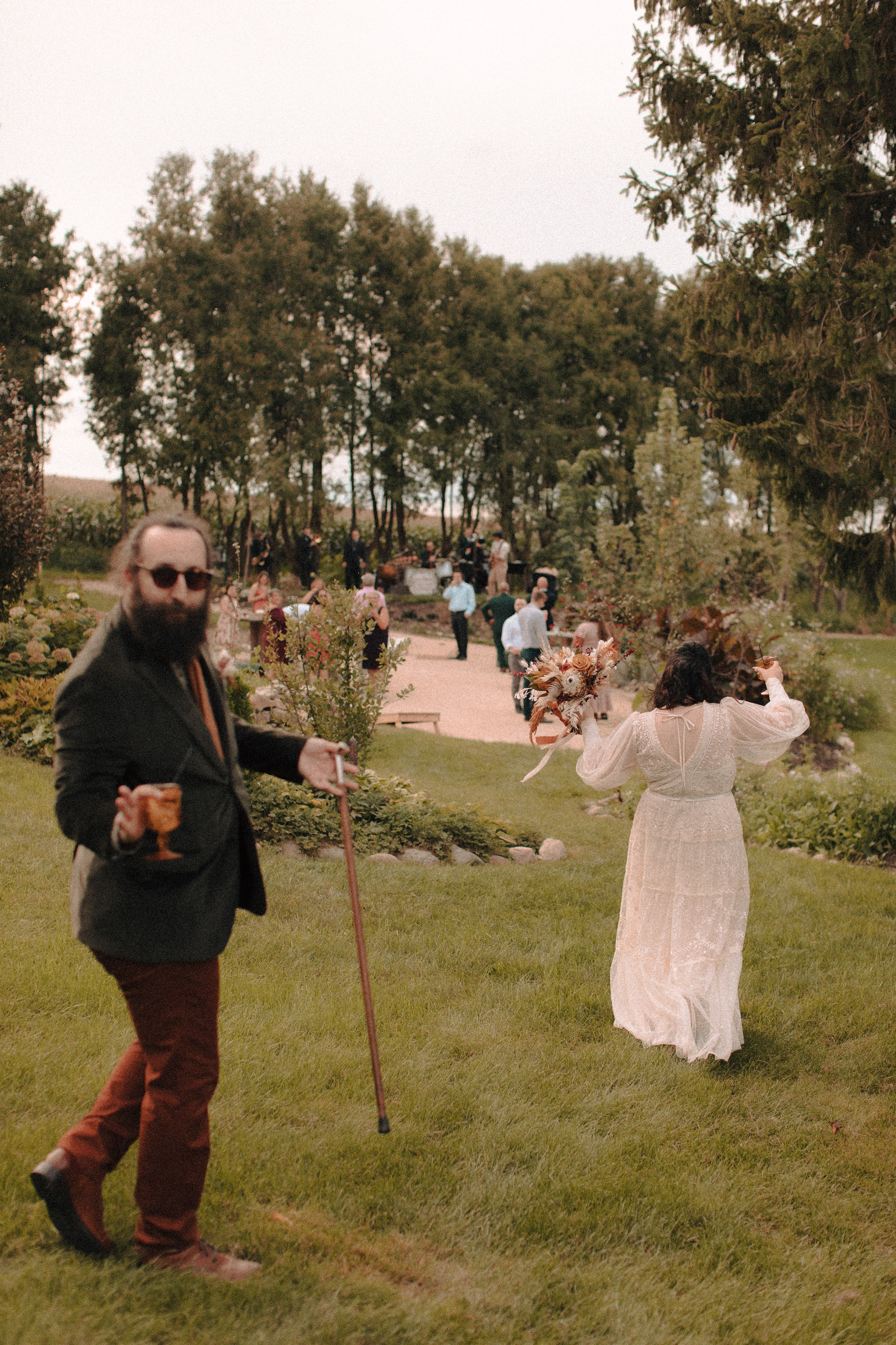 Groom celebrating cocktail hour with amber glass in hand