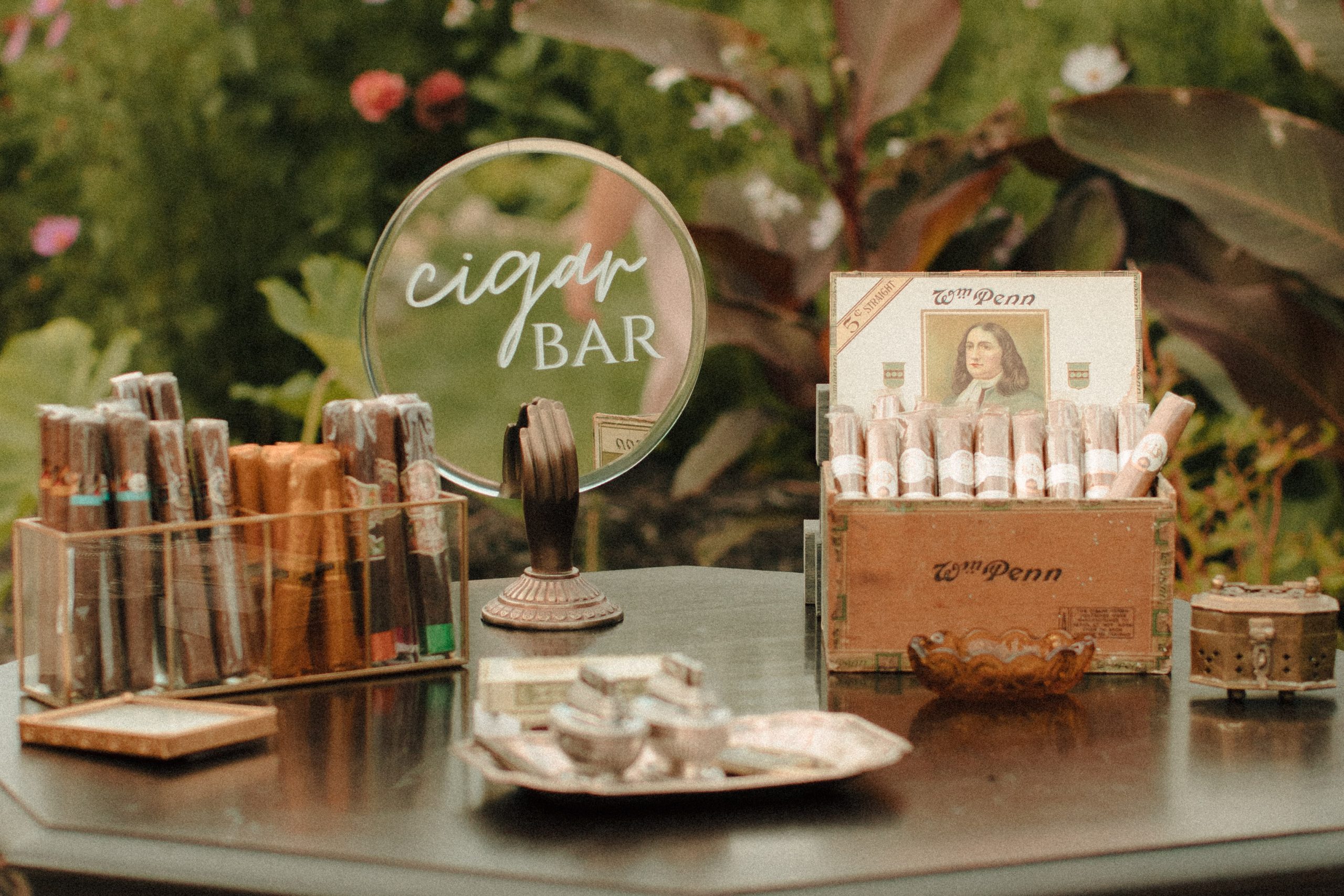 Speakeasy inspired cigar bar at a wedding with vintage lighters
