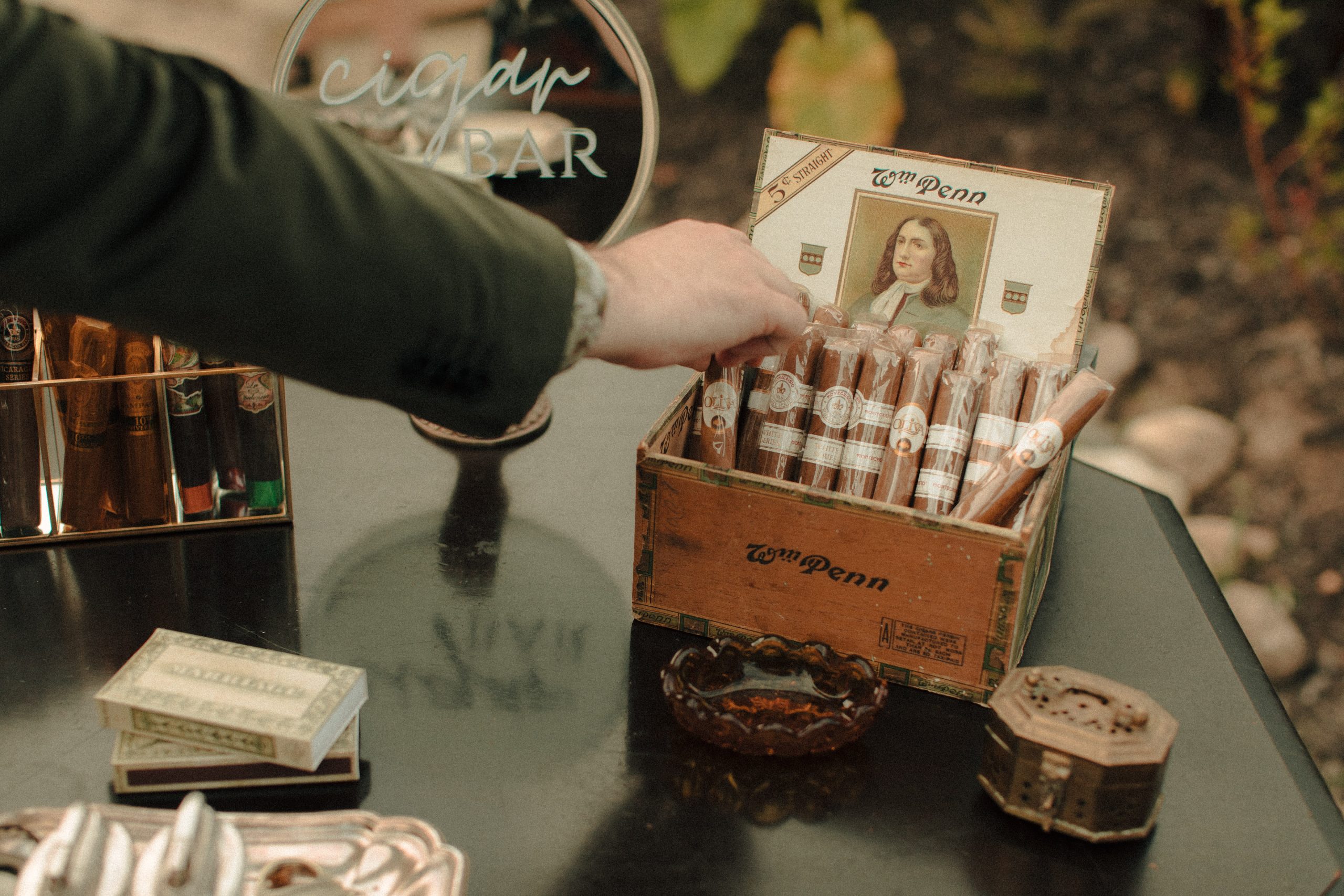 Speakeasy inspired cigar bar at a wedding with vintage lighters