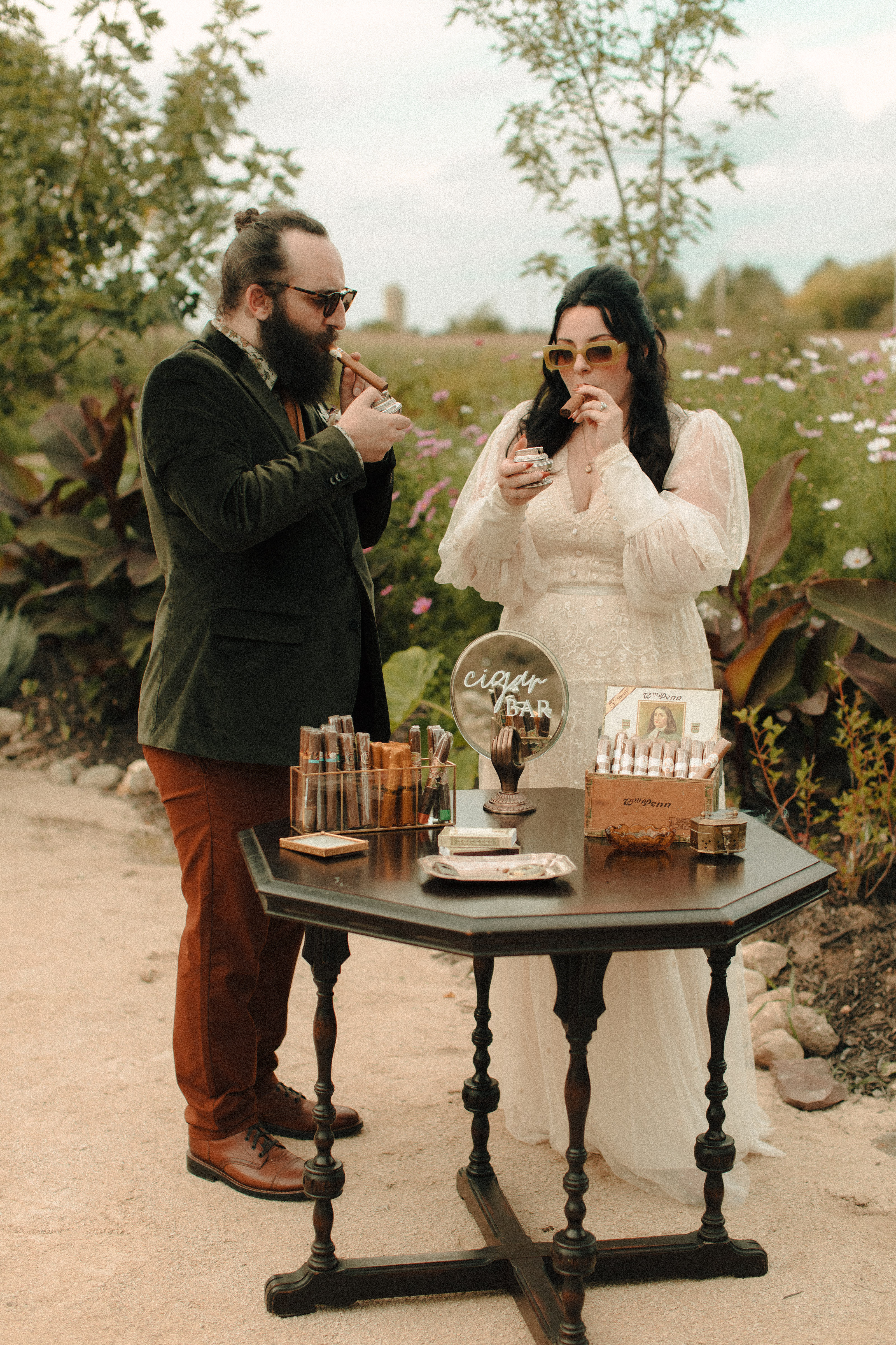 Couple smoking at Speakeasy inspired cigar bar at a wedding with vintage lighters