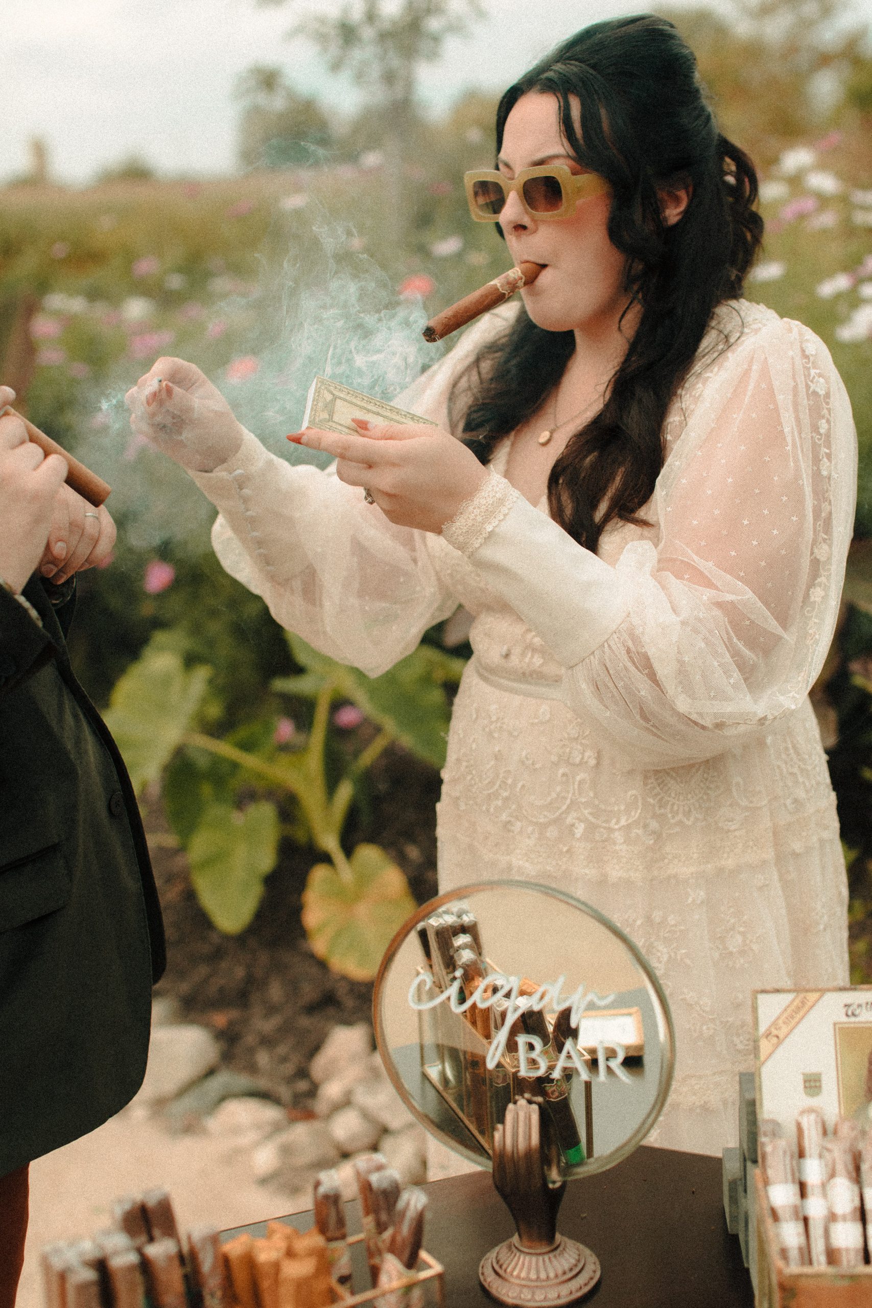Couple smoking at Speakeasy inspired cigar bar at a wedding with vintage lighters