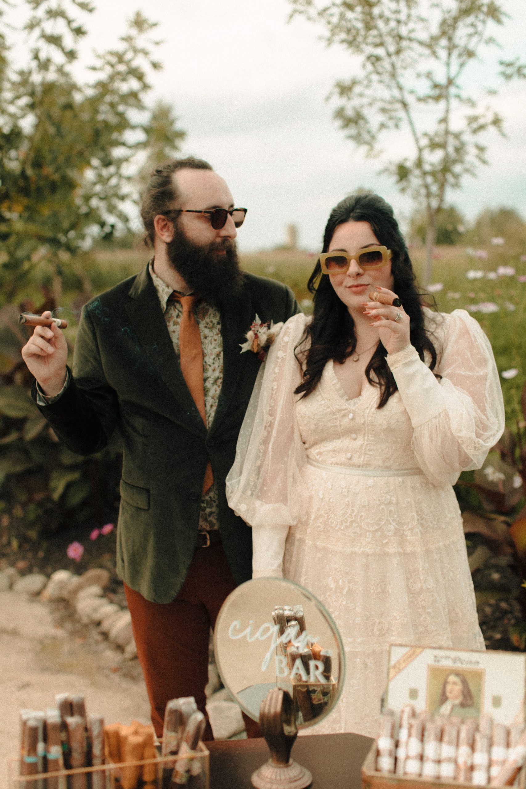 Couple smoking at Speakeasy inspired cigar bar at a wedding with vintage lighters