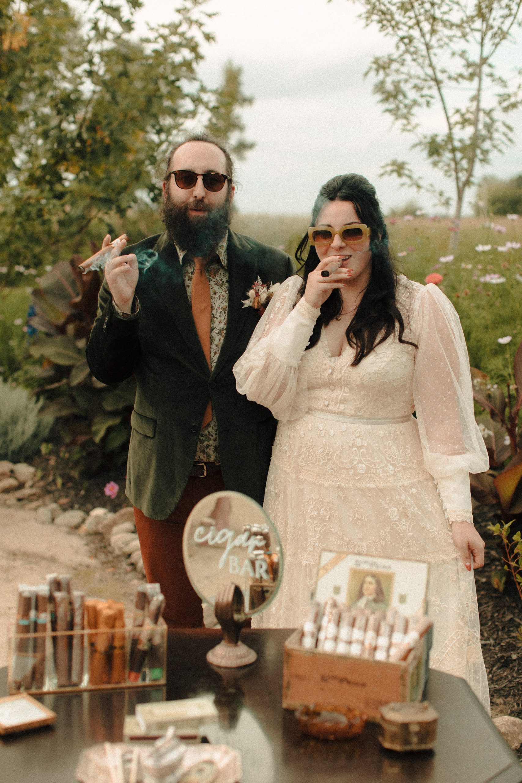 Couple smoking at Speakeasy inspired cigar bar at a wedding with vintage lighters