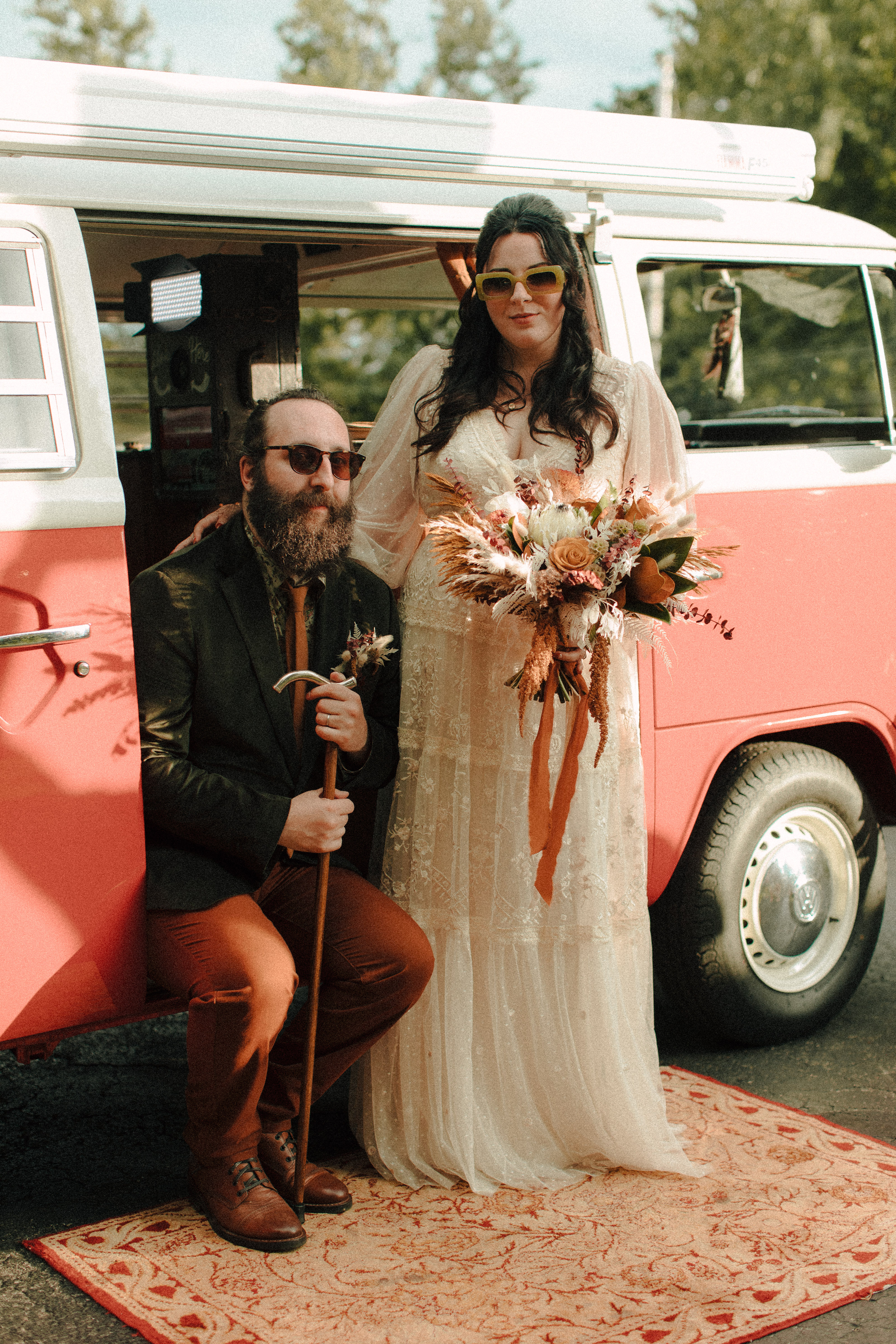 Vintage bride and groom sitting in a retro VW bus