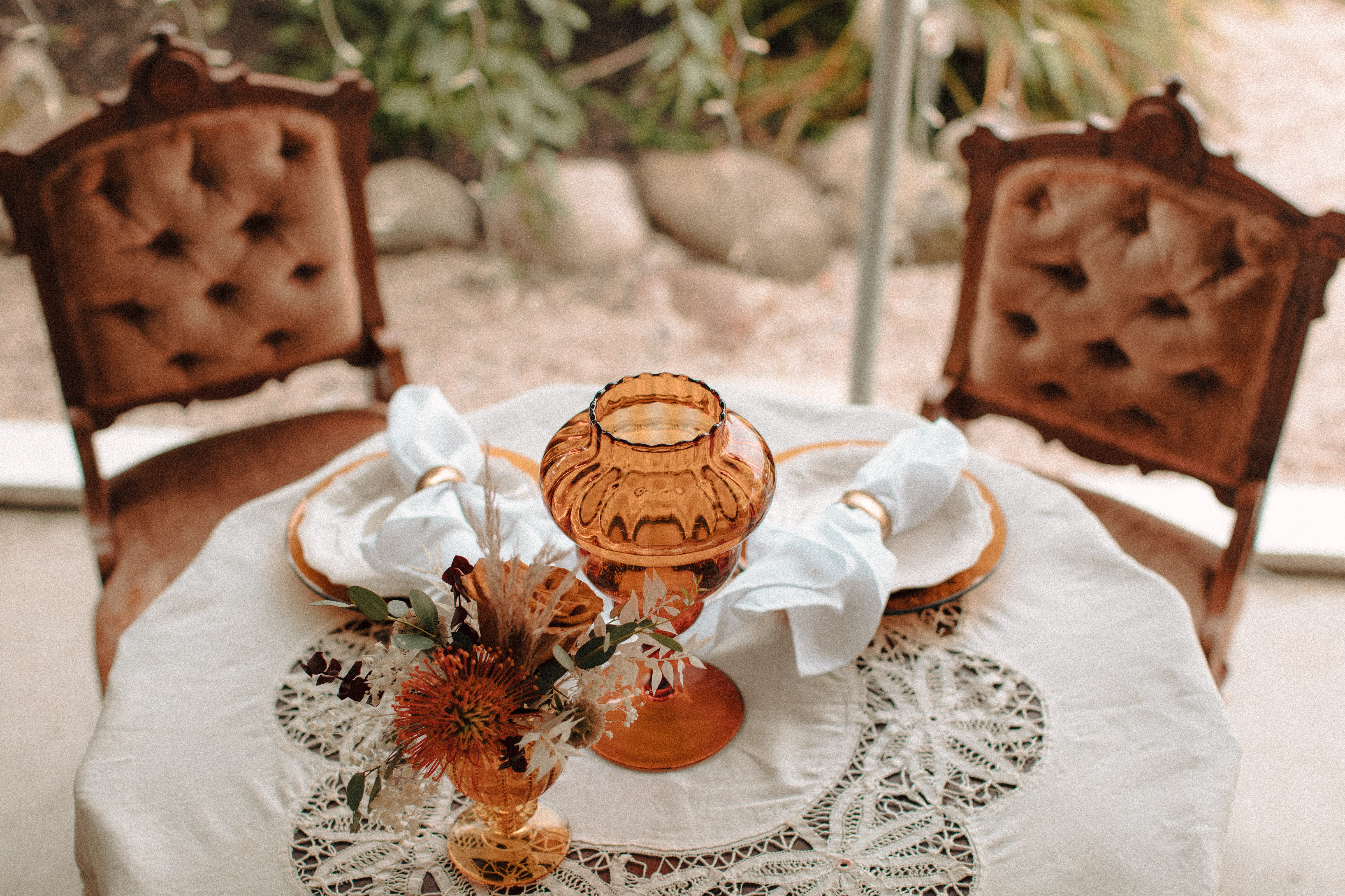 Sweetheart table with crocheted table cloth and orange centerpiece