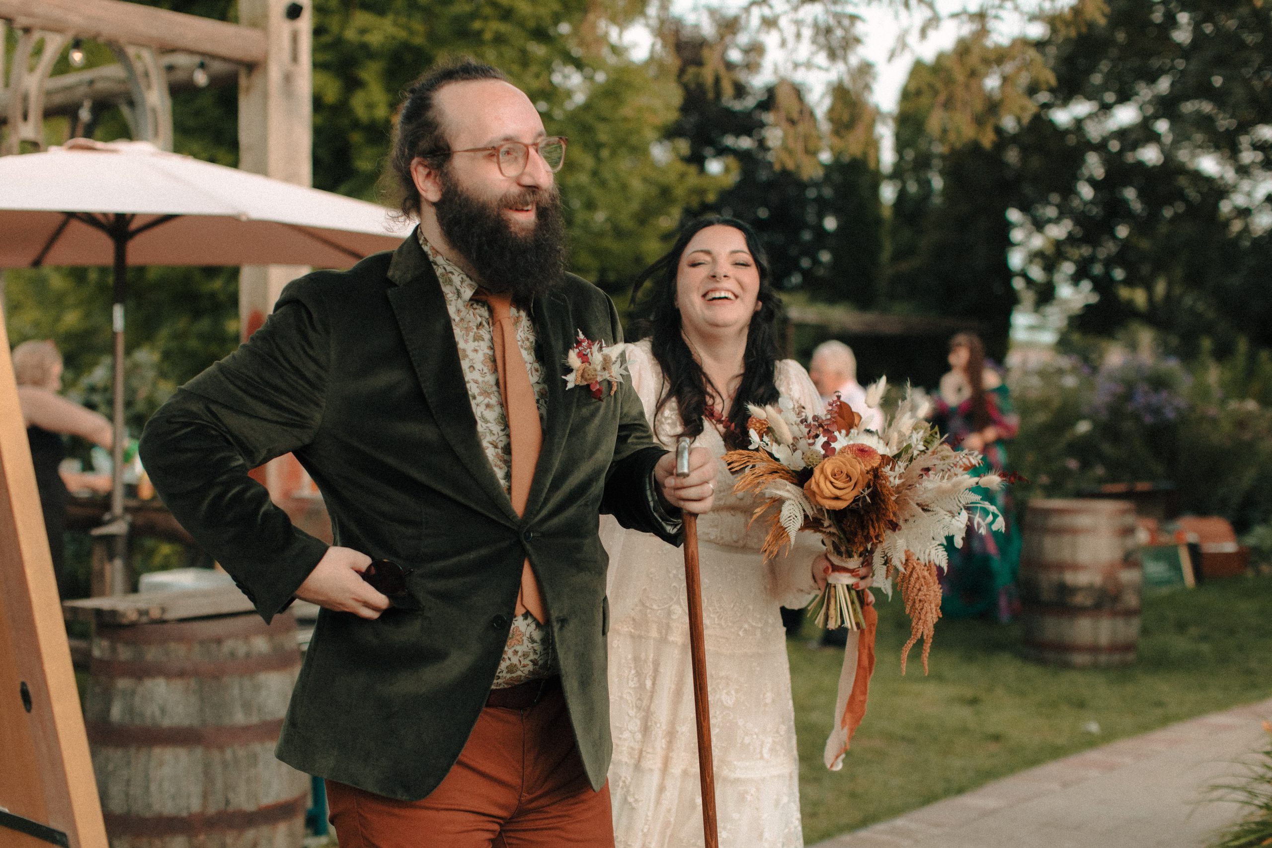 Bride and groom laughing as they enter wedding reception