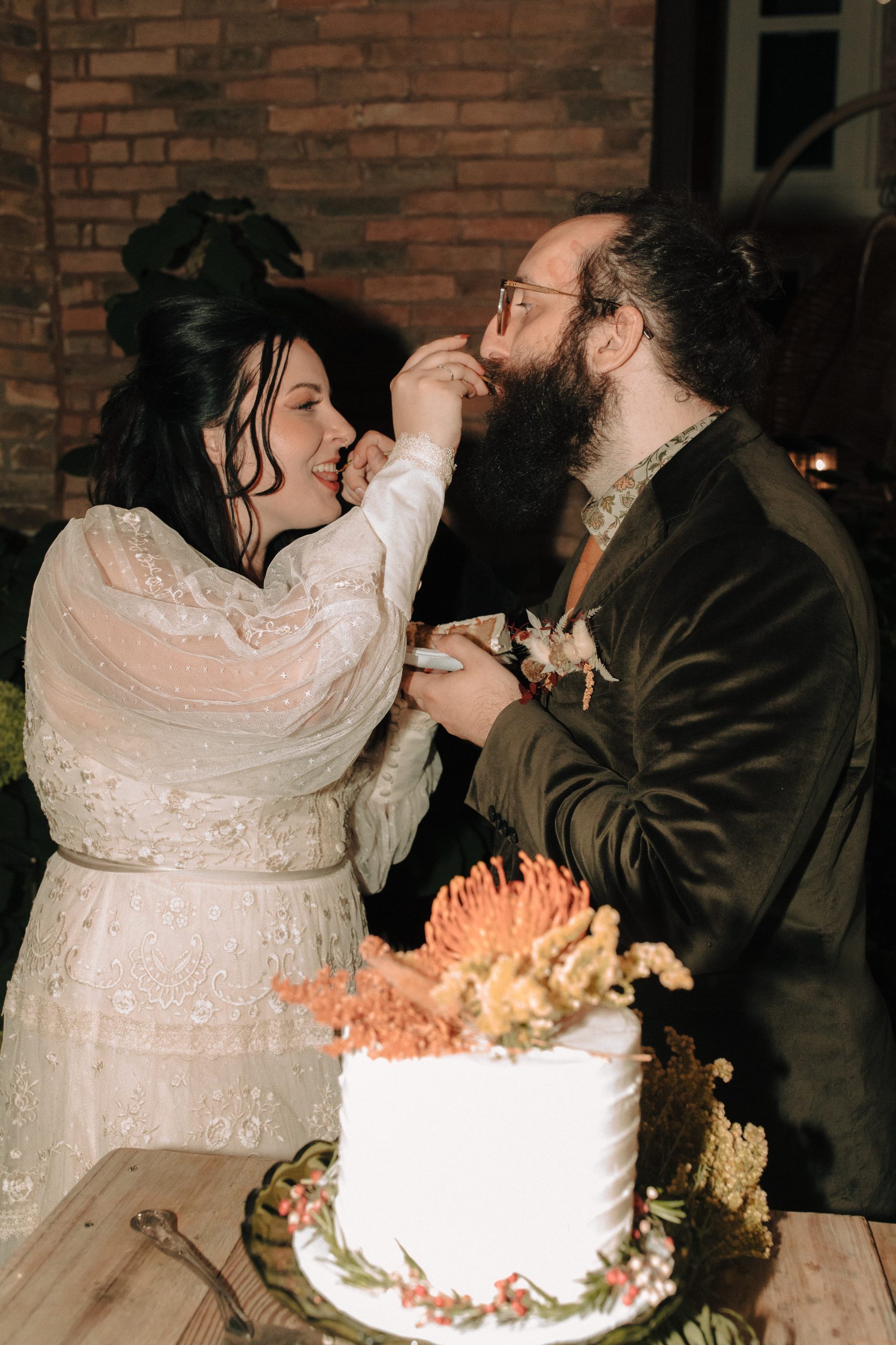 Bride and groom feeding each other cake