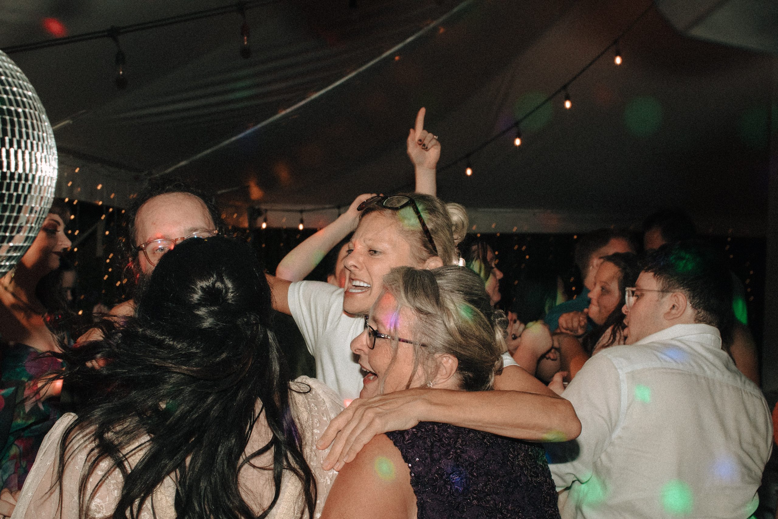 Family dancing under a tent at a wedding